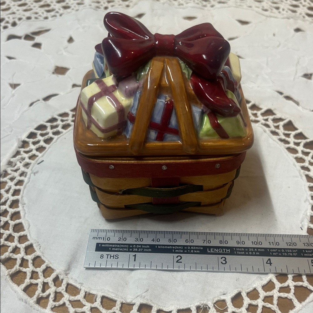 Longaberger 2006 Little Gifts Basket with a pottery lid.